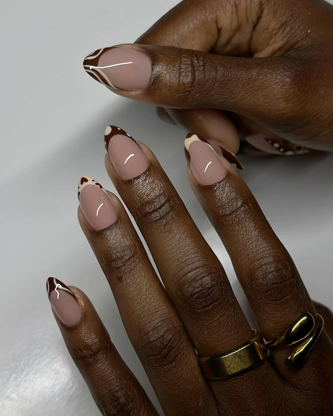 pale almond nails with outlined dark brown tips