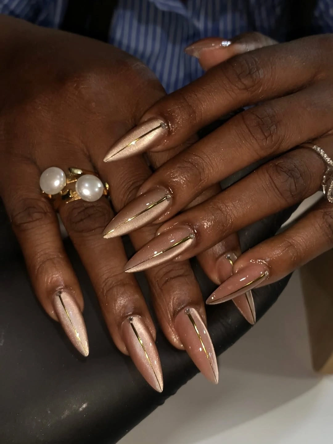 very long nude stiletto nails with fine gold lines