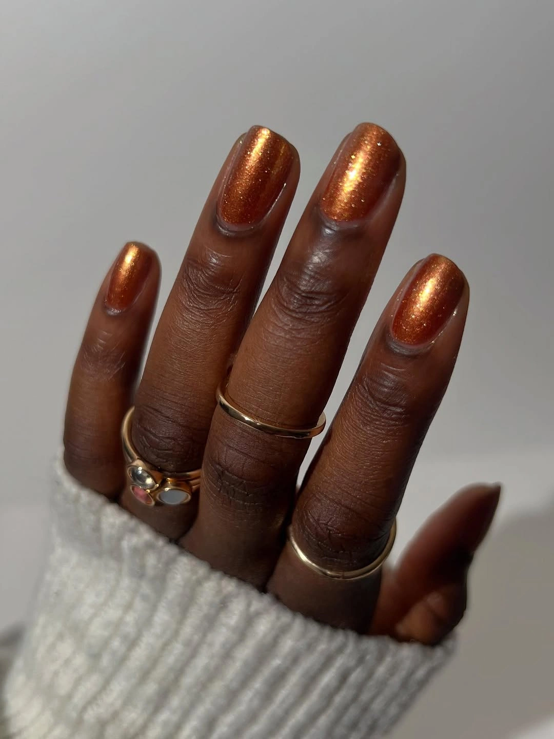 short rounded metallic copper-orange nails