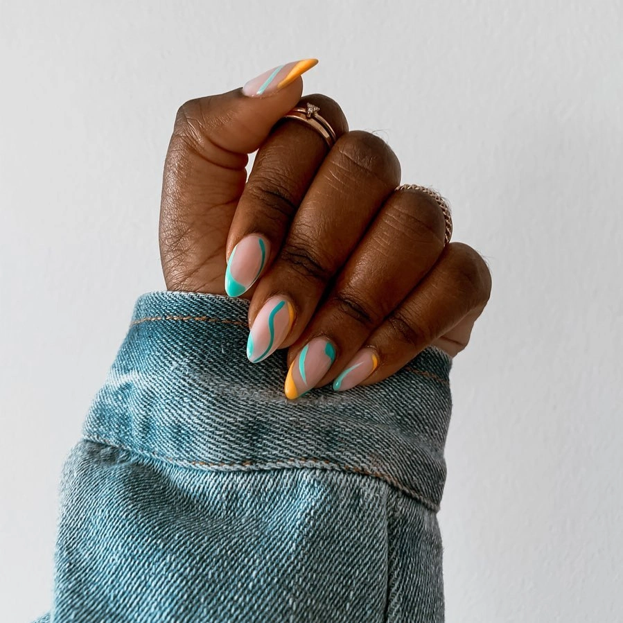 nude almond nails with turquoise and orange tip lines