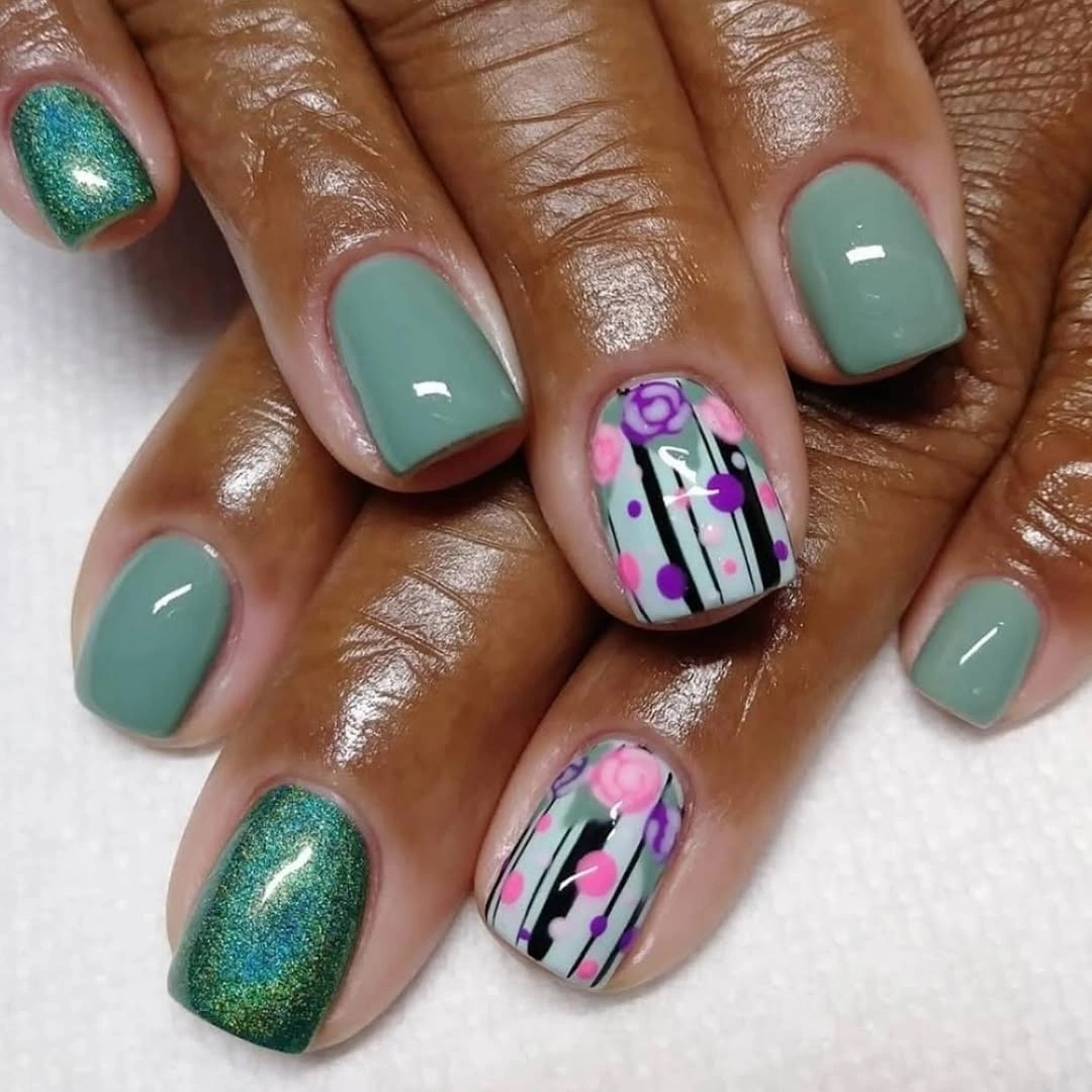 short mint nails with pink floral grid accents on dark skin