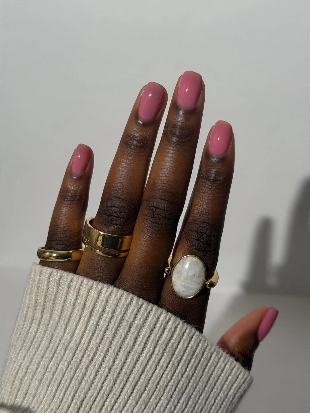 short rounded glossy dusty-pink nails on dark skin