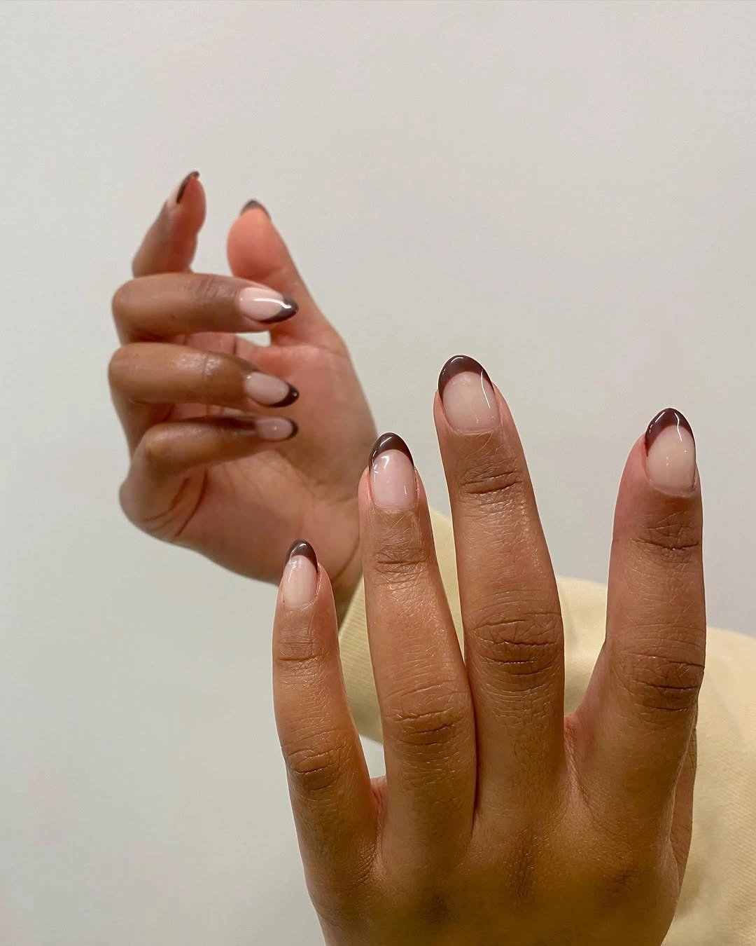 pale almond nails with deep brown French tips
