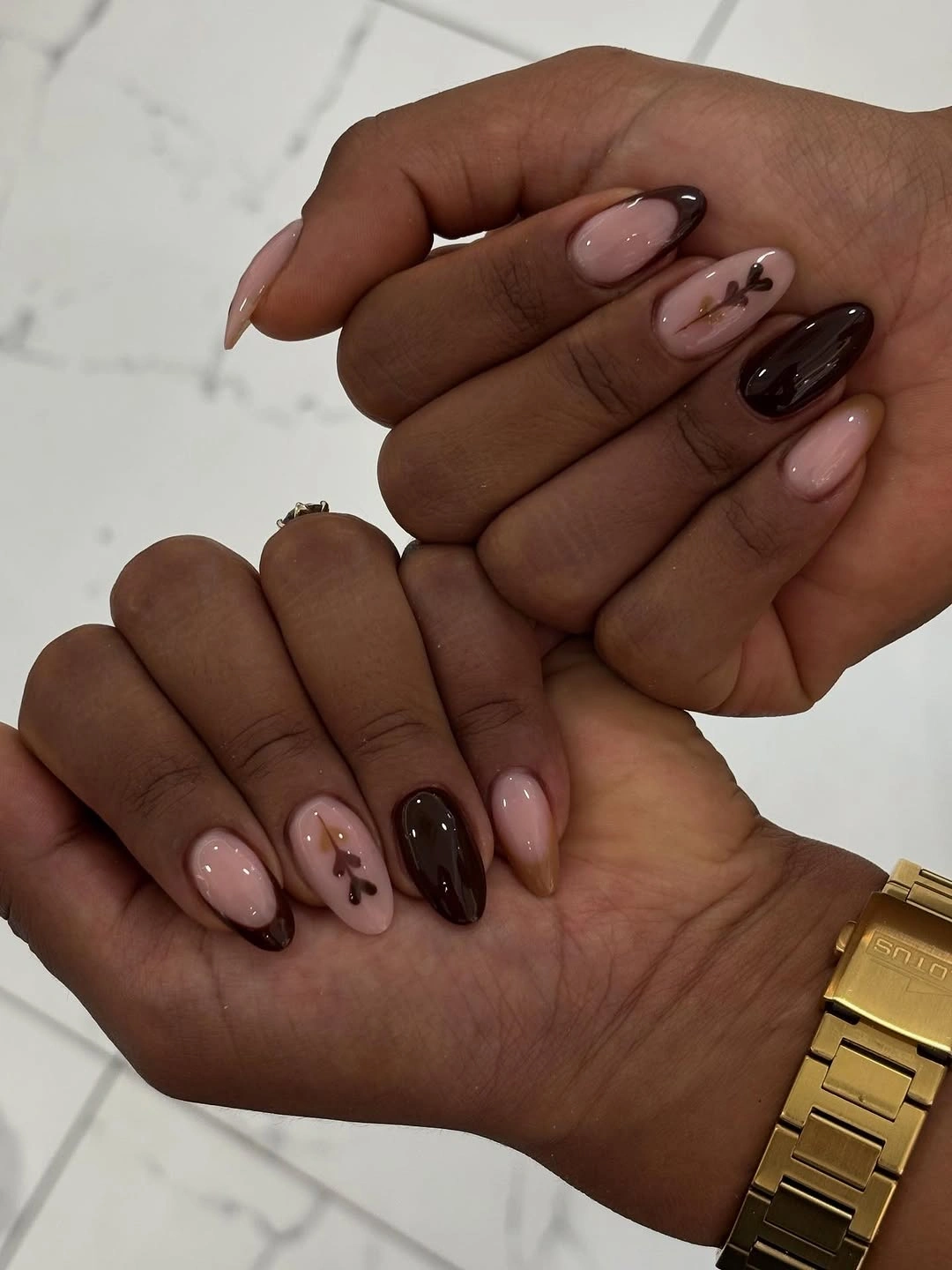 mixed brown blush and nude almond nails with small accents