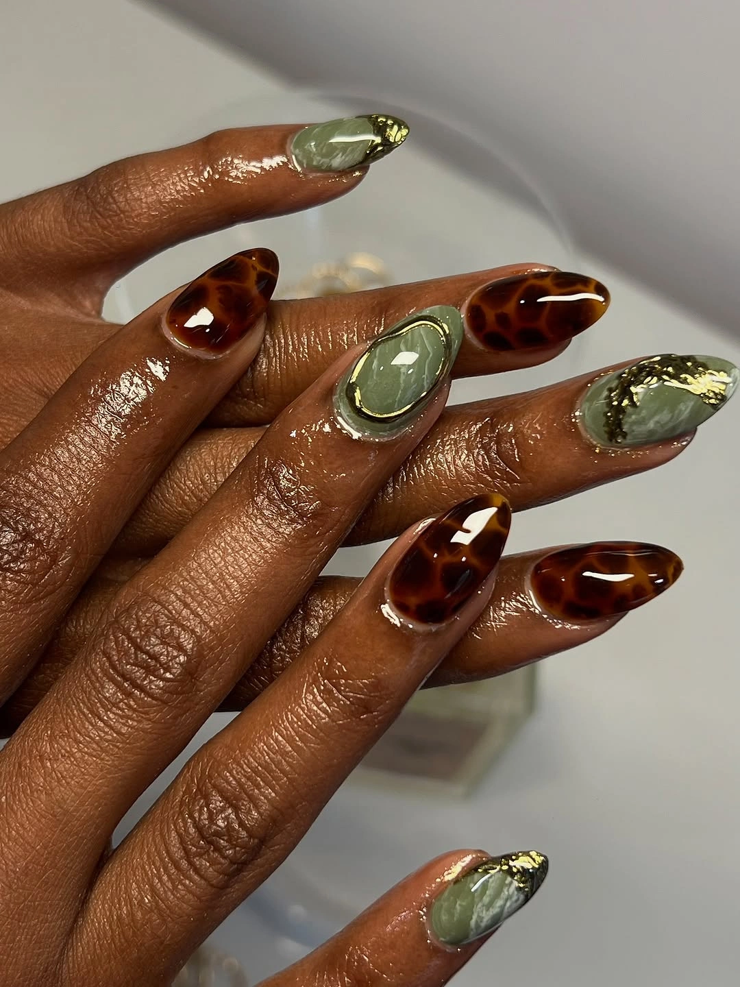 Amber olive and pale almond nails with fine borders