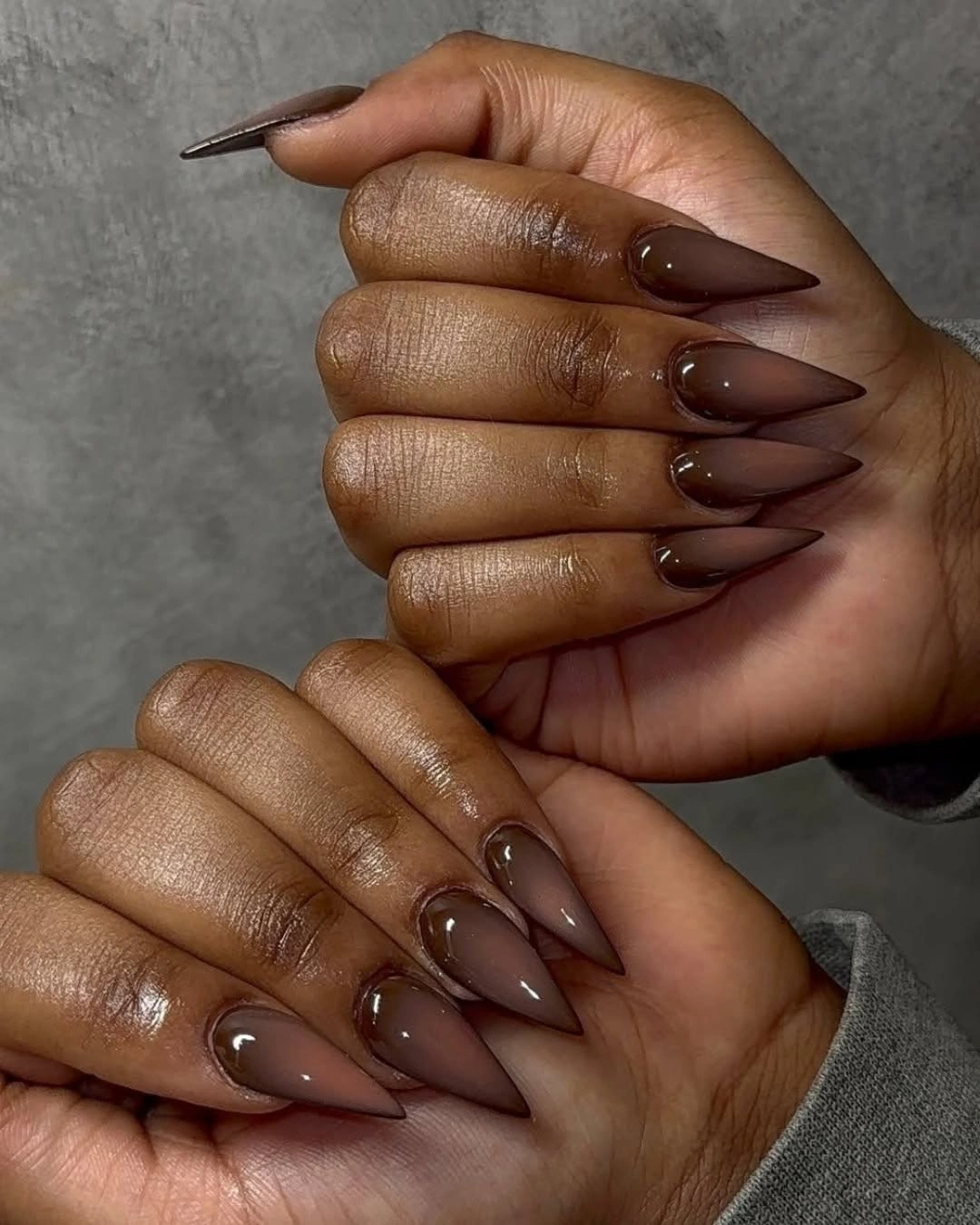 Uniform glossy deep brown on very long pointed nails