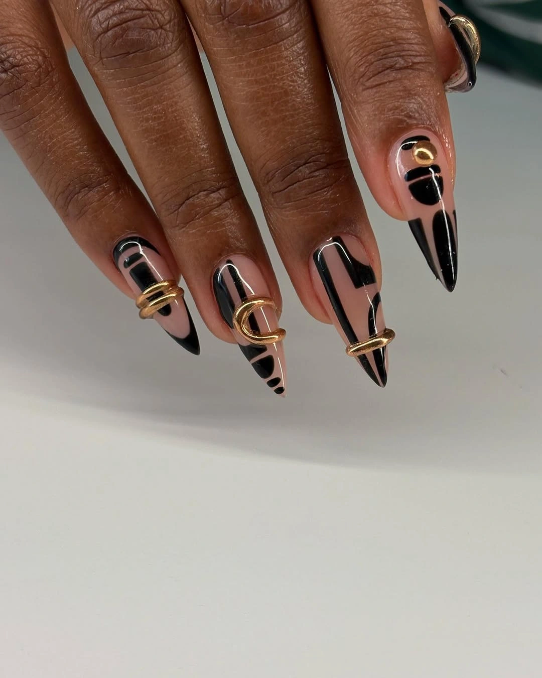 black nude and gold graphic stiletto tips