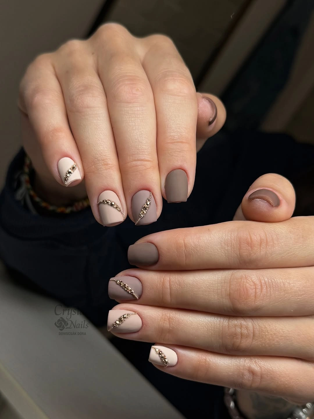 Short taupe nails with tiny reflective accent details