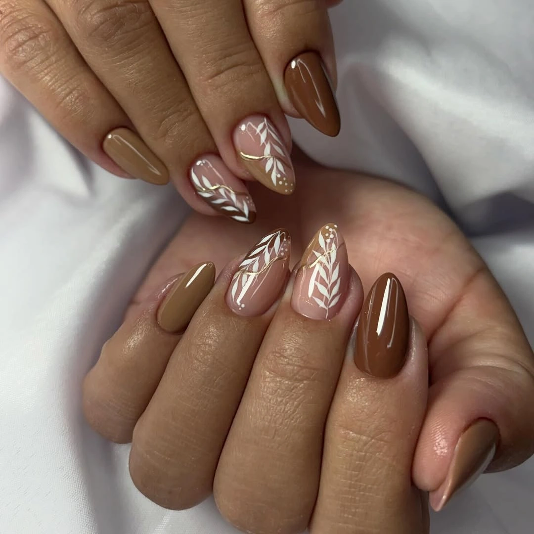 Taupe brown almond nails with pale botanical line accents