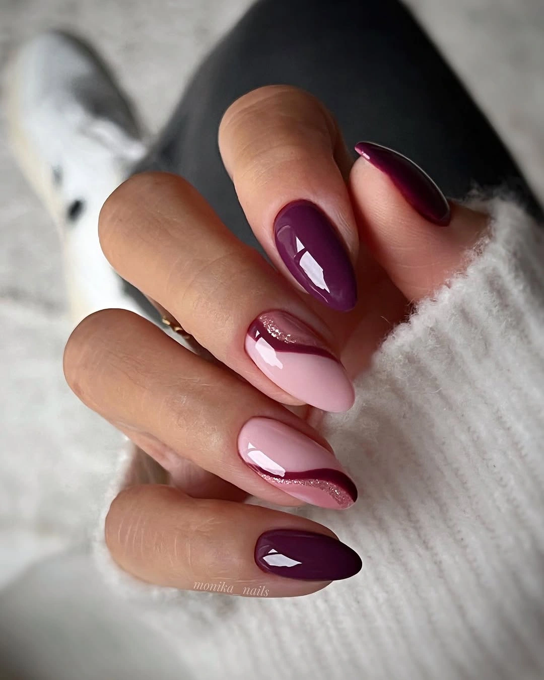 Plum almond nails with burgundy curved negative space