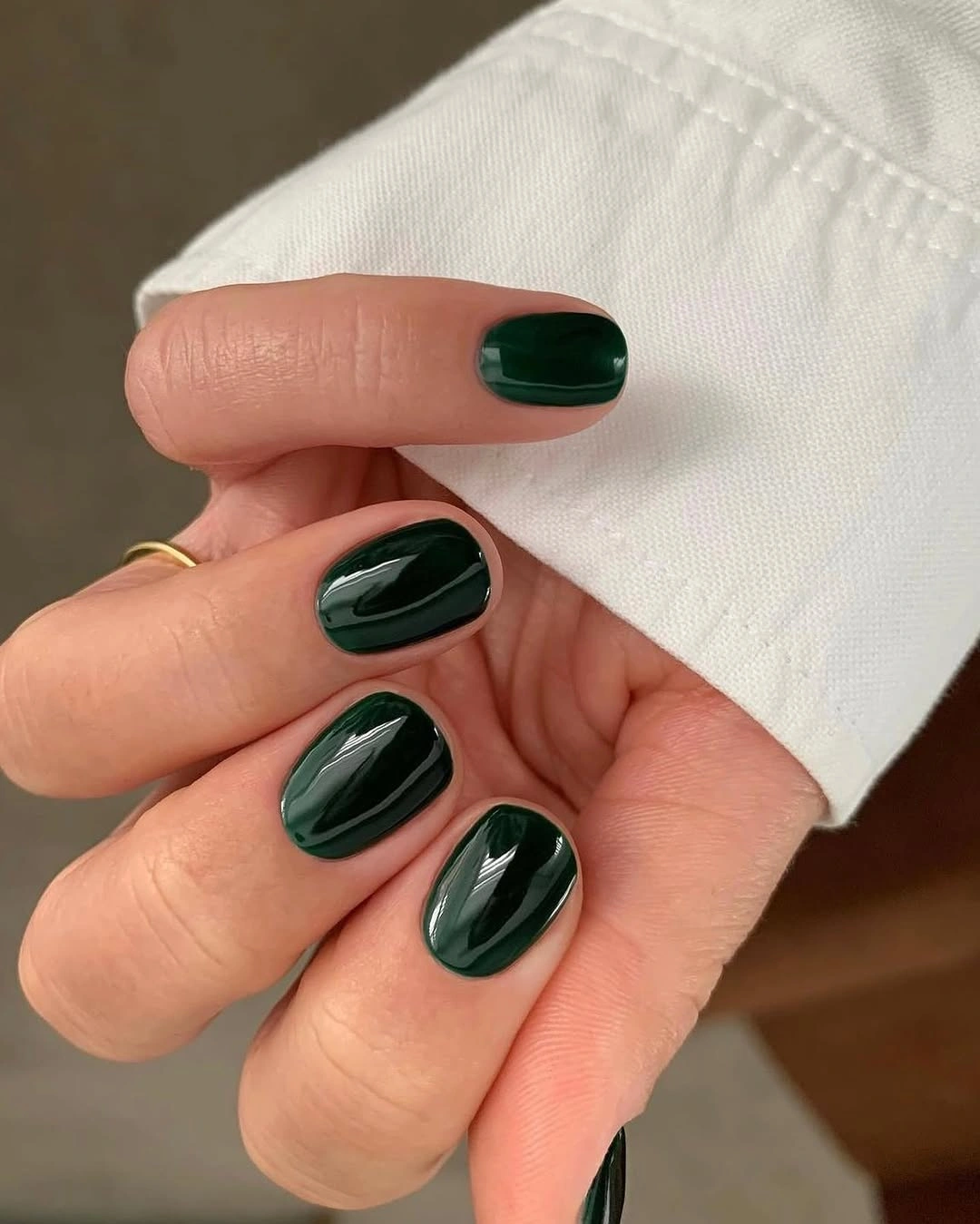 Deep forest green on short rounded nails
