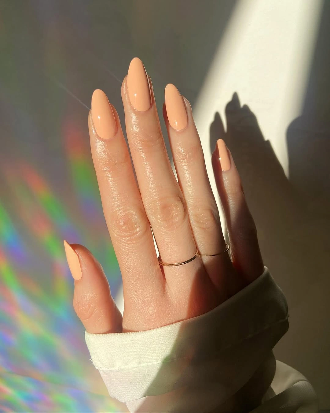 peach nude long almond nails with minimal solid nude