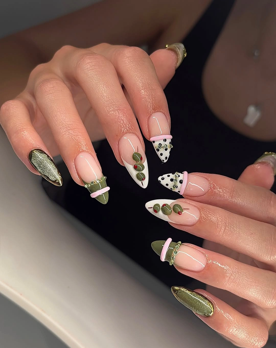 olive long almond nails with dots, lines, botanical marks