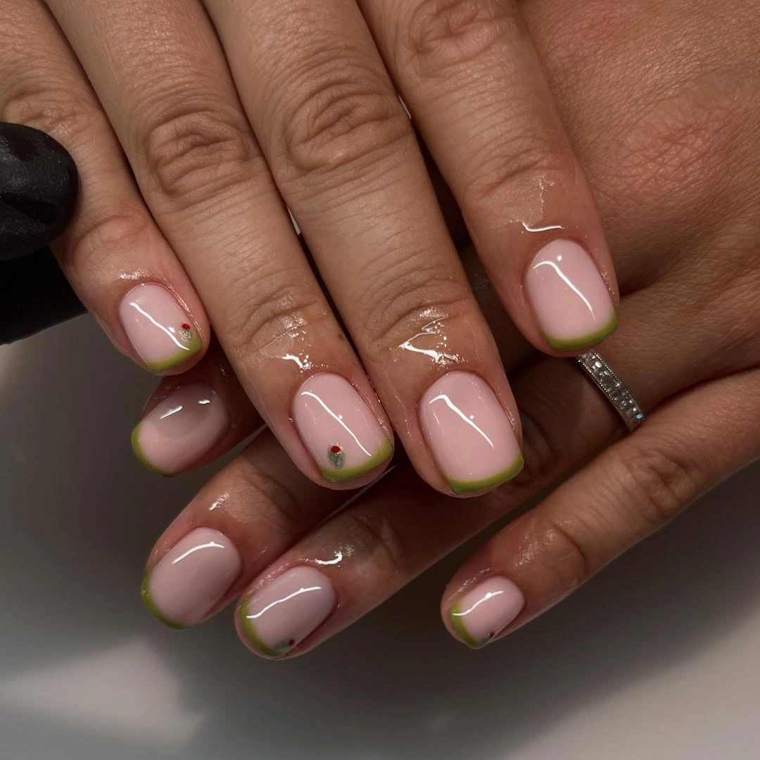 blush pink short rounded nails with olive tips and dots