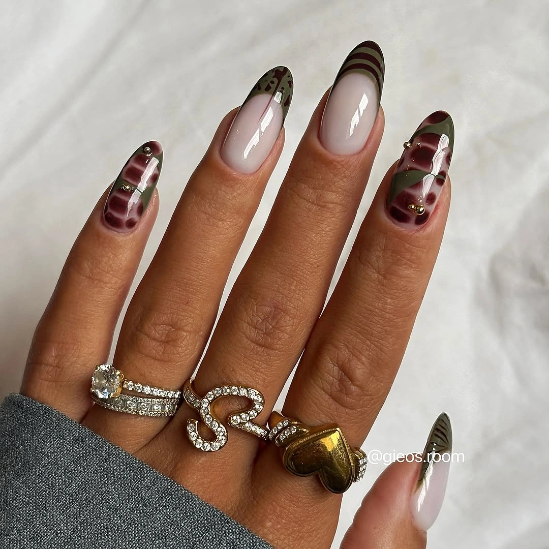 pale pink long almond nails with curved bands and metallic dots
