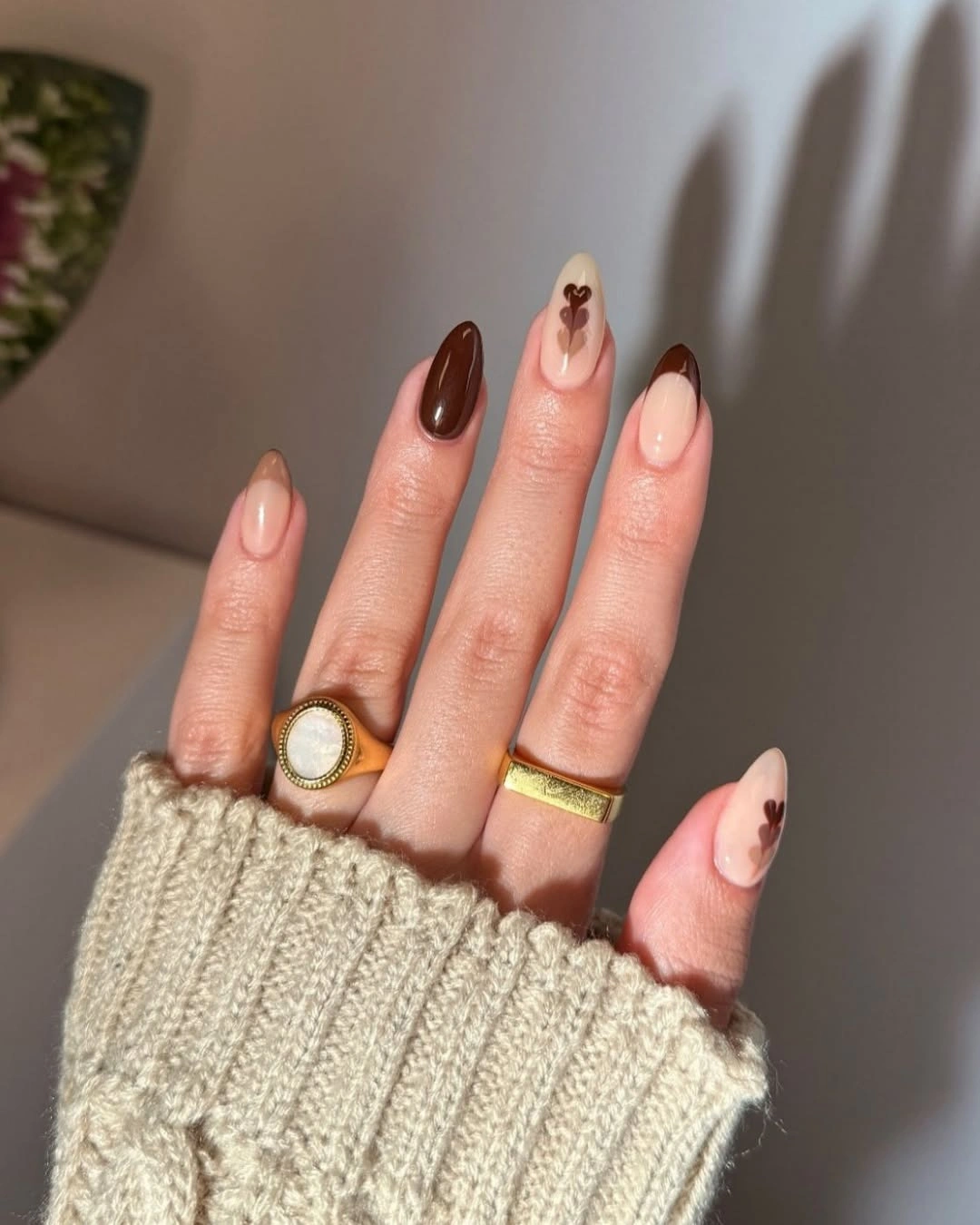 chocolate brown long almond nails with tiny heart accent