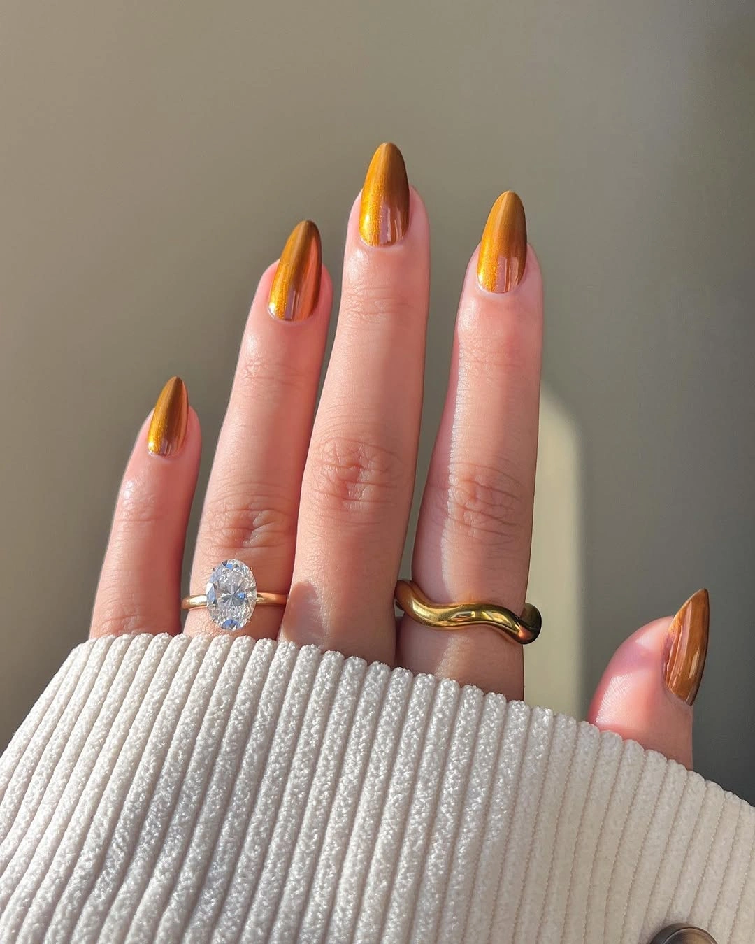 gold orange metallic long almond nails with single metallic shade
