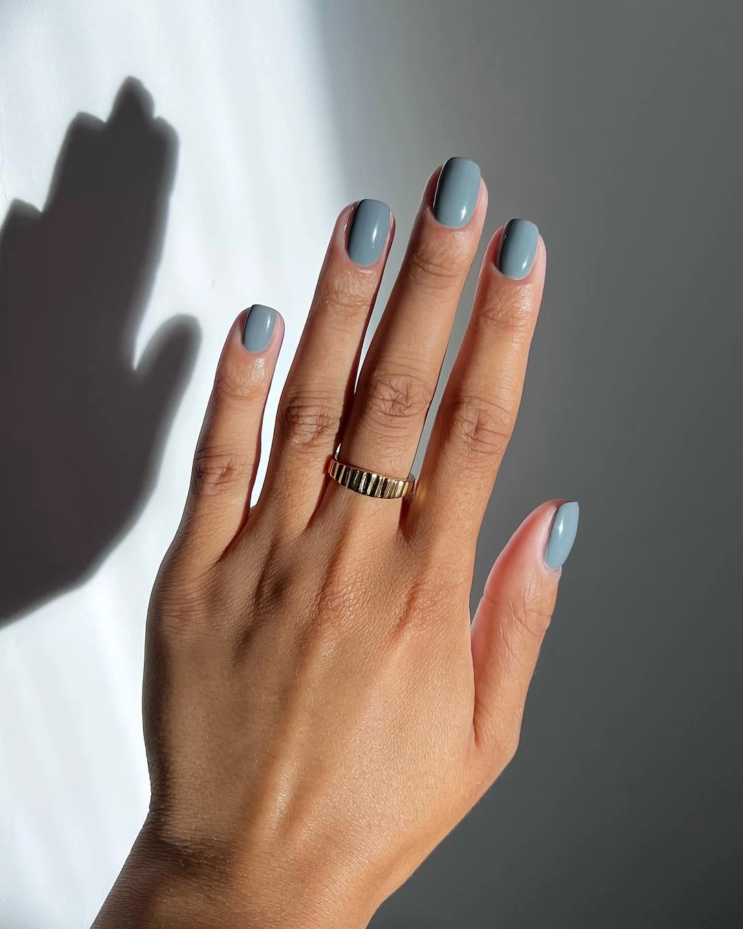 Glossy pale blue on short rounded-square nails