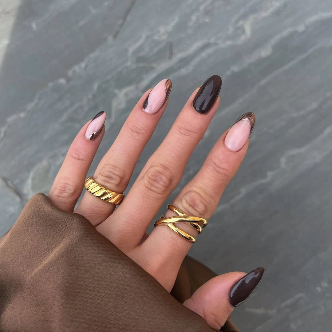 Pale almond nails with brown green and warm tip accents
