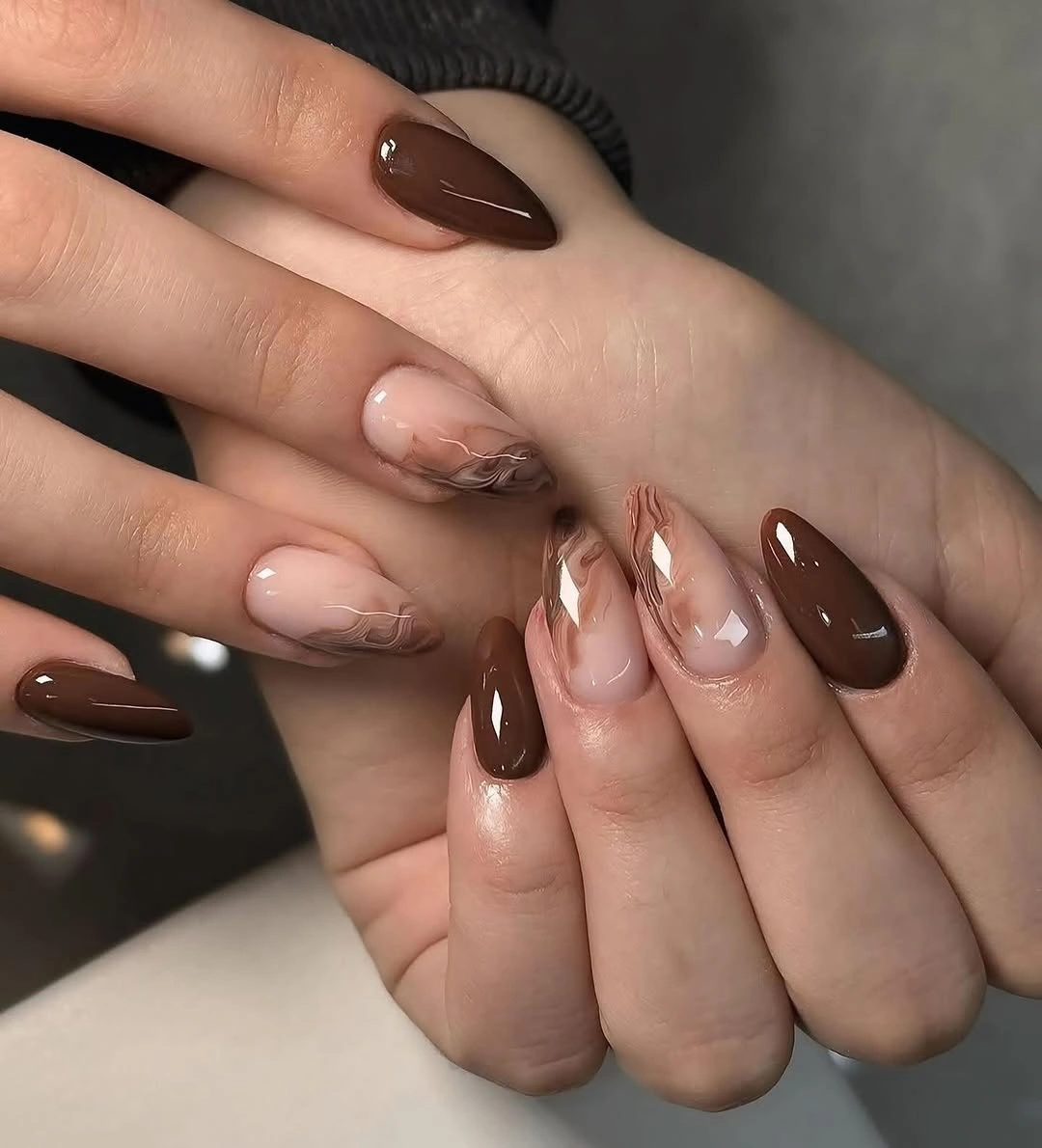 Glossy chocolate almond nails with pale nude accents