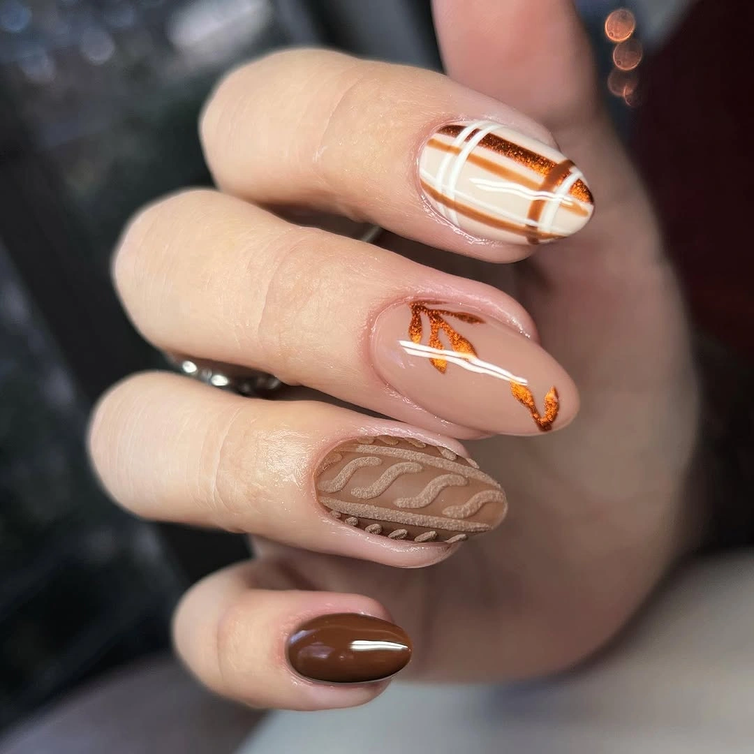 Fall nail idea: medium almond nude brown orange linear manicure