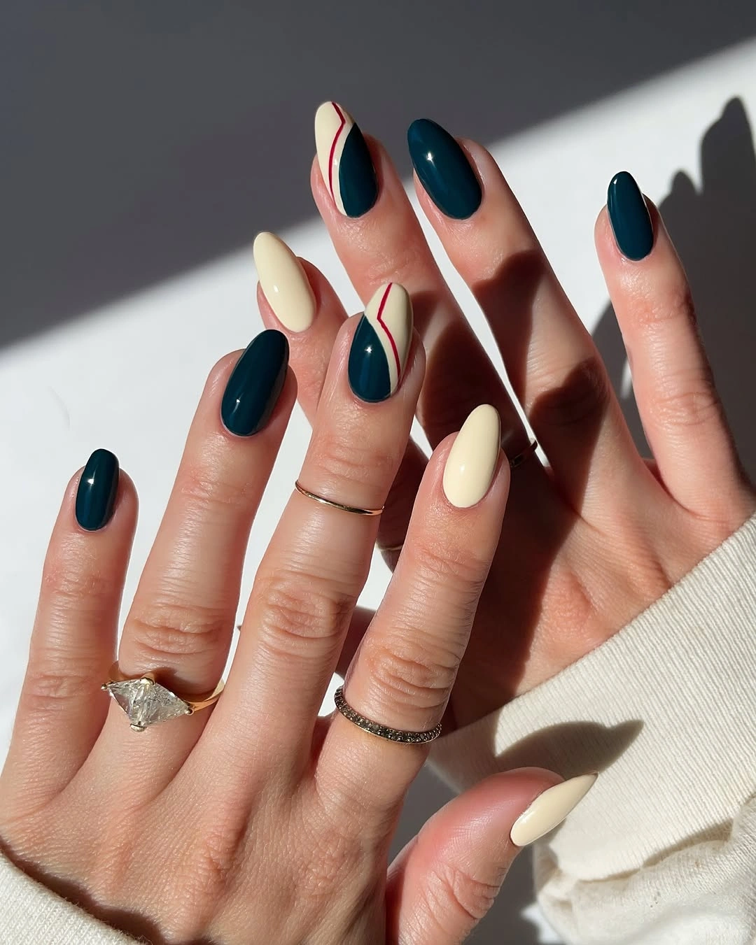 Fall nail idea: long almond teal and cream geometric manicure