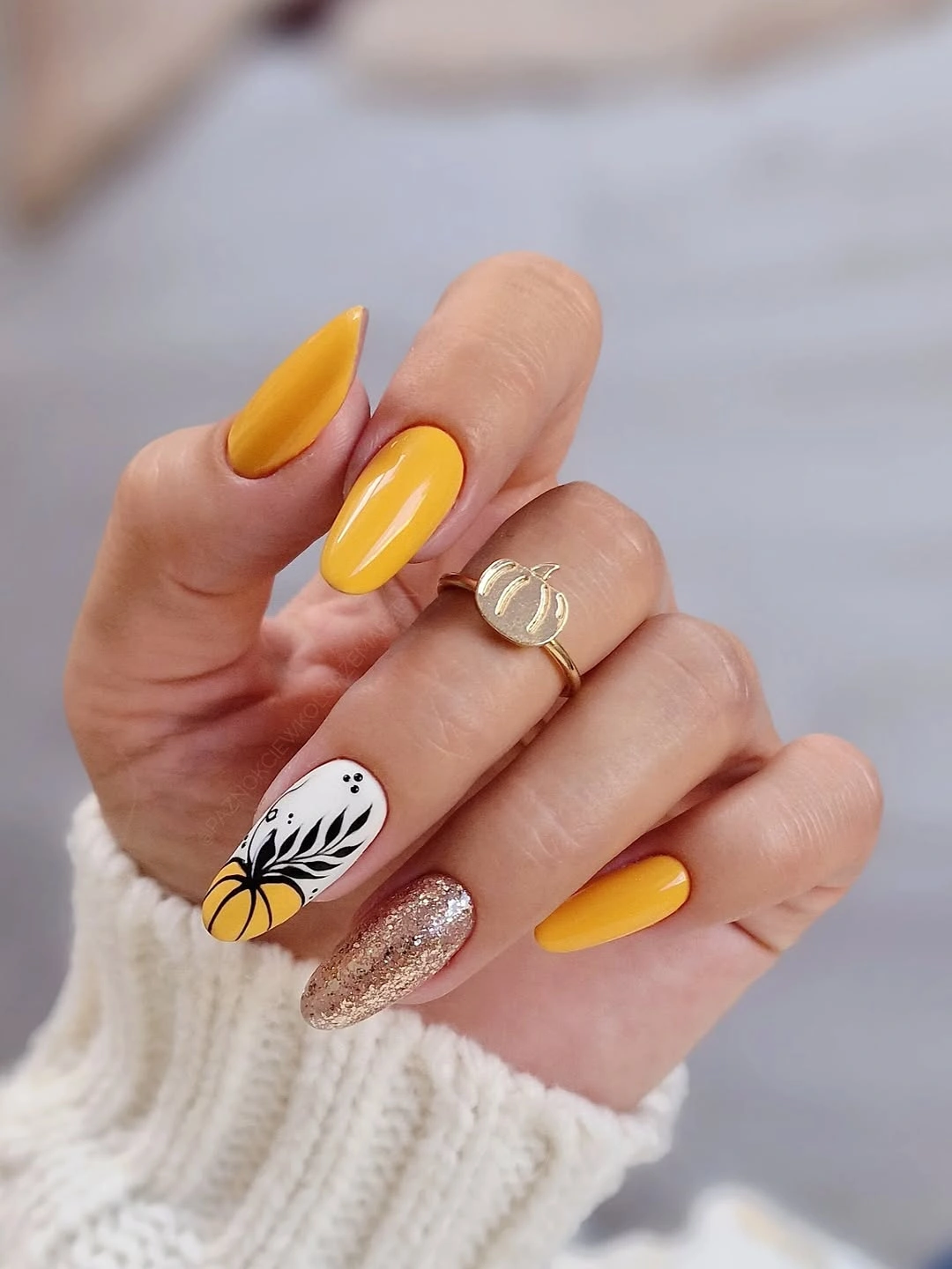 Long almond yellow orange nails with pumpkin line art