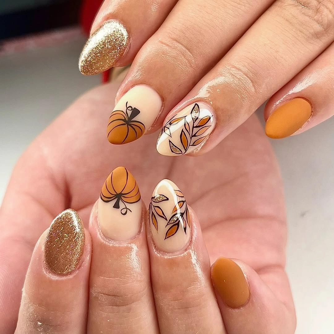Medium almond mustard brown nails with cream pumpkins and leaves