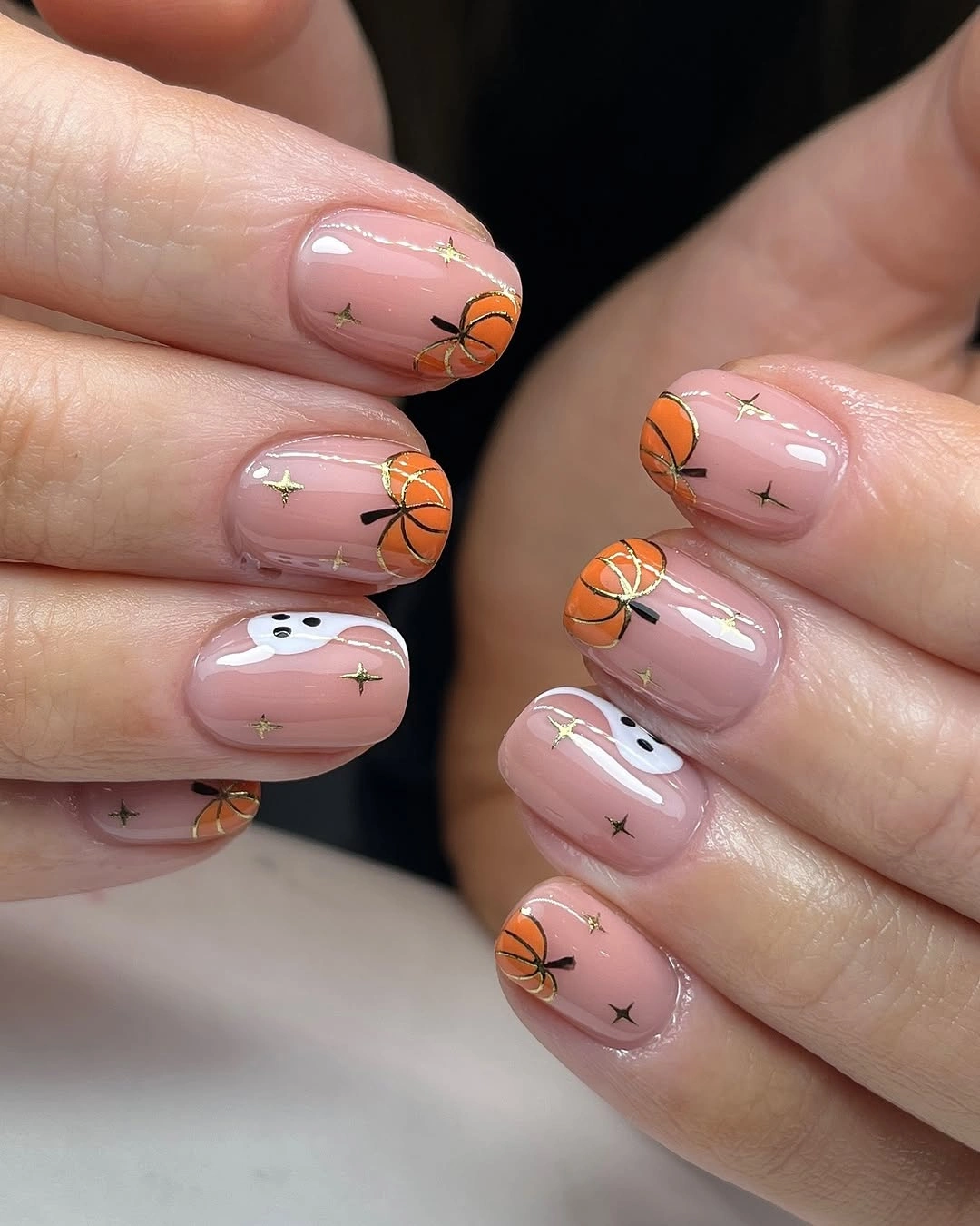 Short squoval pink nails with pumpkins ghosts and stars