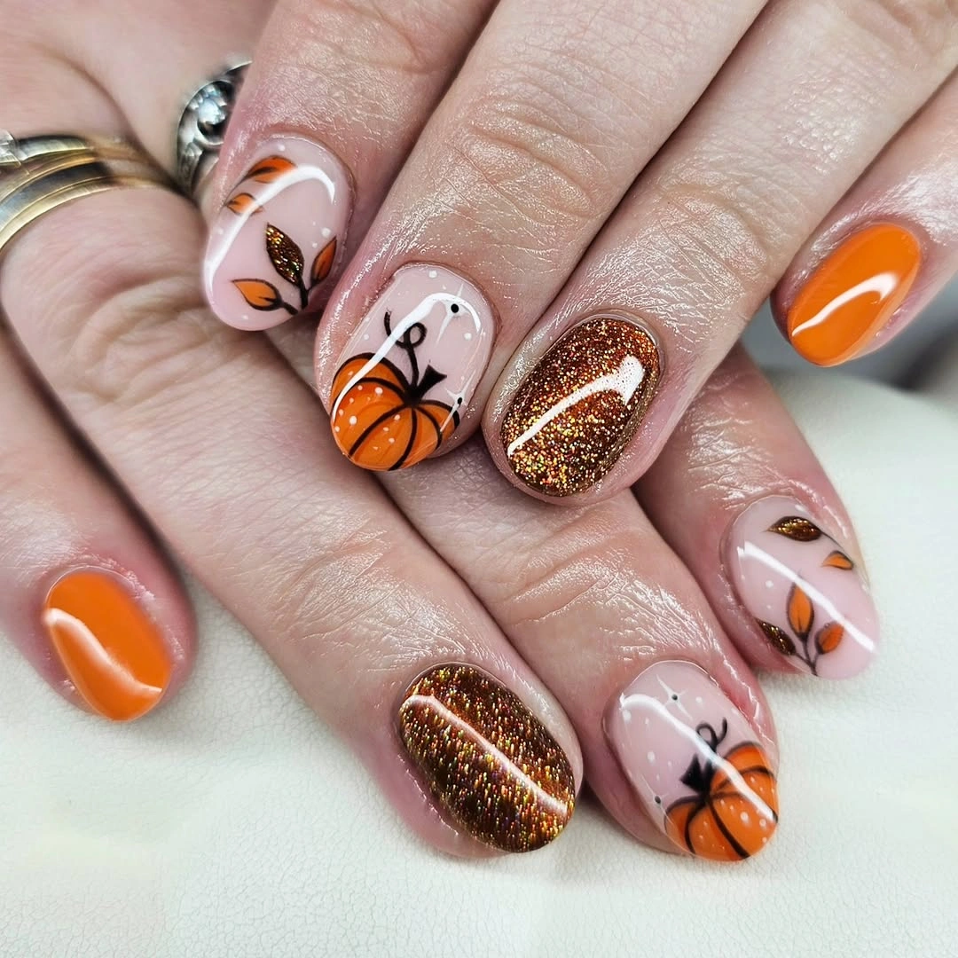 Short almond orange burgundy nails with white pumpkins and glitter