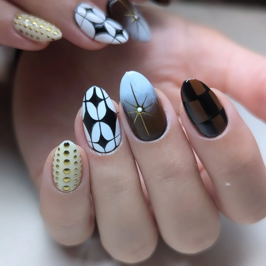 short almond nails with brown white and black graphics