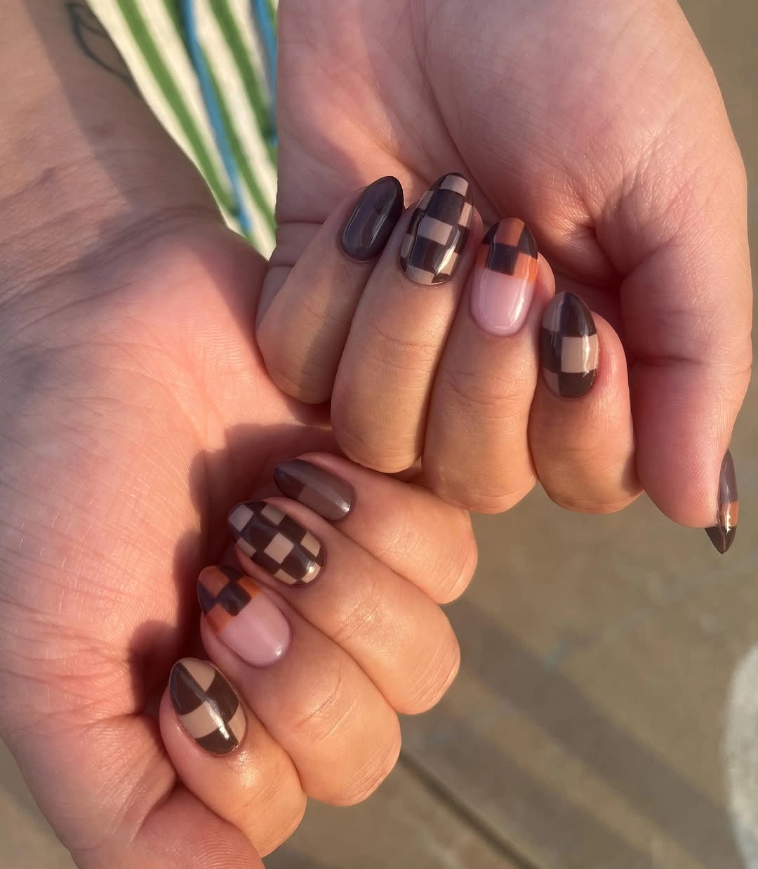 short burgundy almond nails with silver star accents