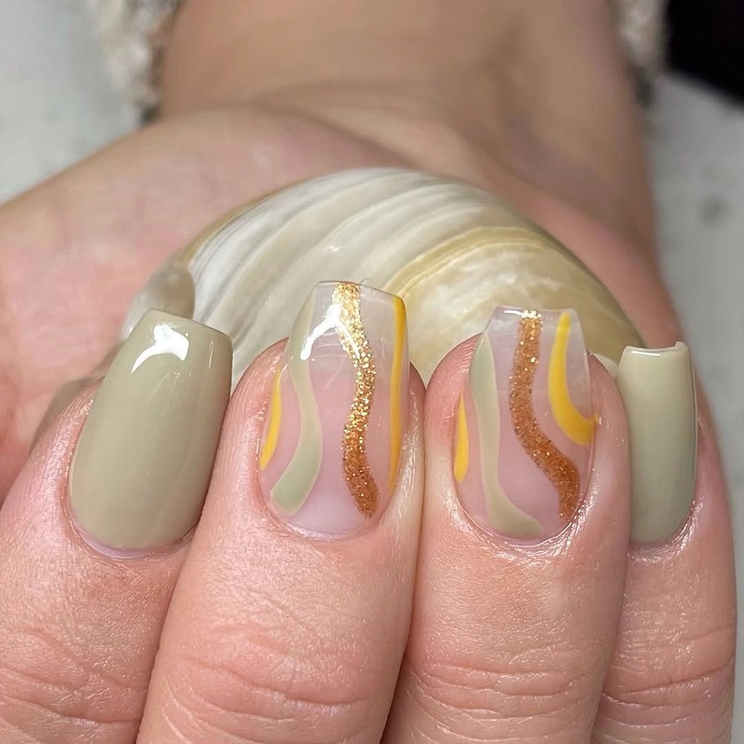 short beige square nails with olive and gold curved lines