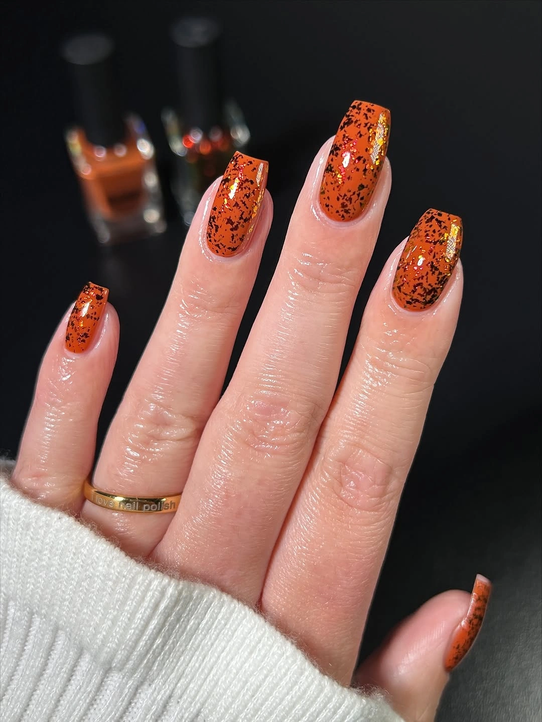 medium square orange nails with dark reflective flecks