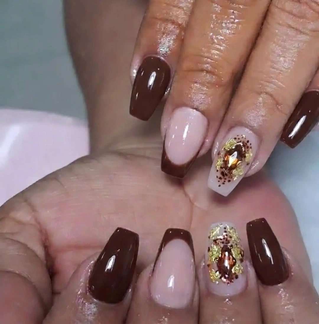 medium square burgundy nails with nude gold foil windows