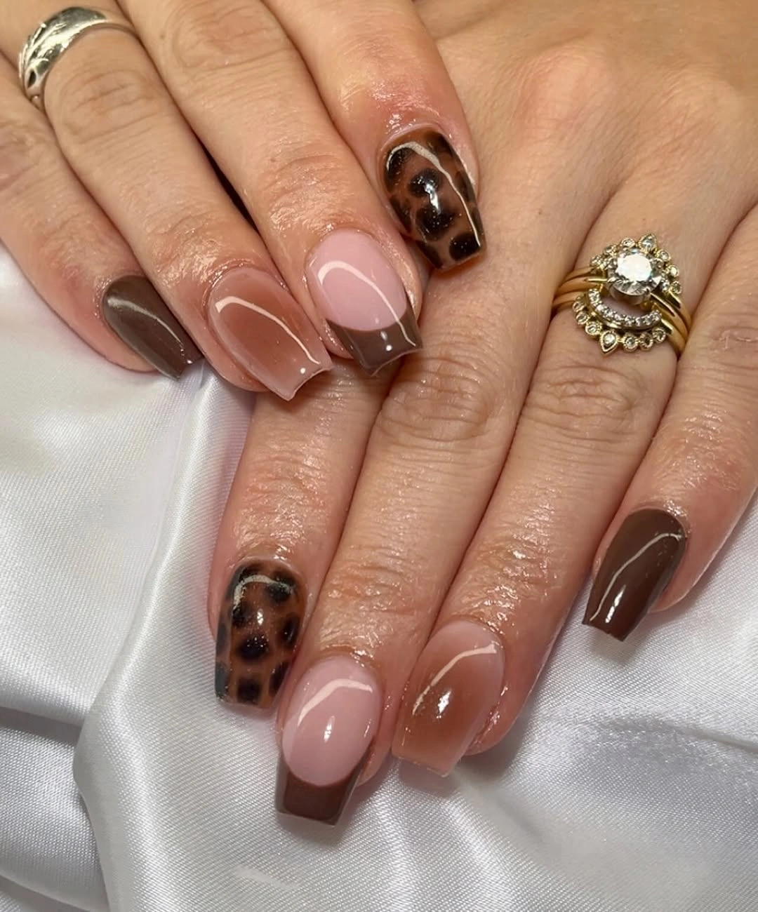 short nude coffin nails with brown tips and spotted accents