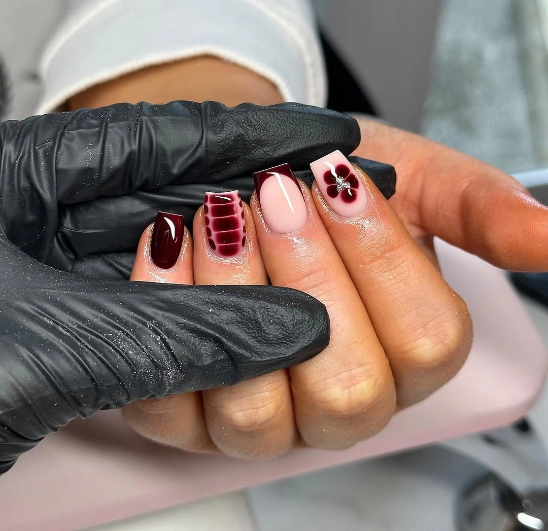 short burgundy square nails with one checked accent