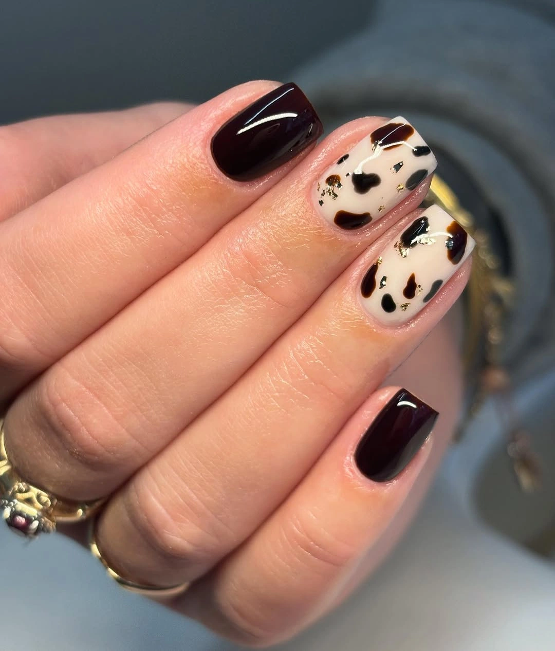 Short square burgundy nails with cream spotted accents