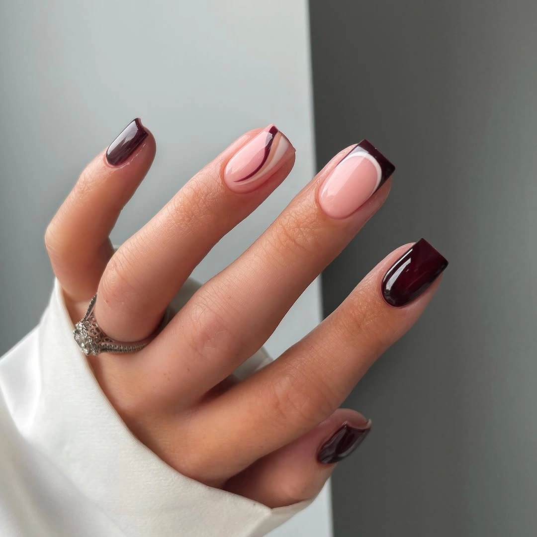 Medium square pale pink nails with curved burgundy French tips