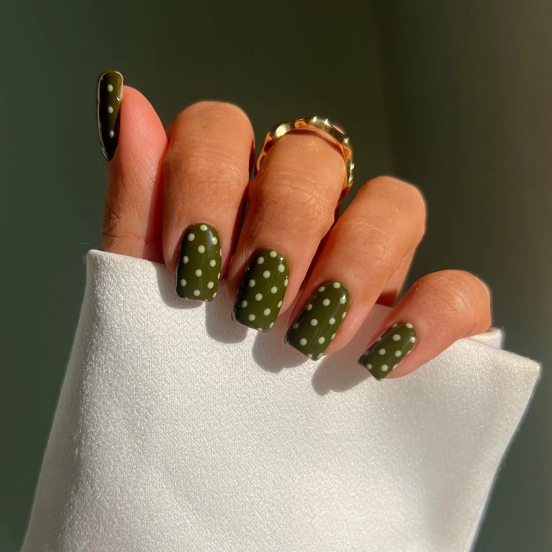 Long square olive nude nails with dots and gold accents
