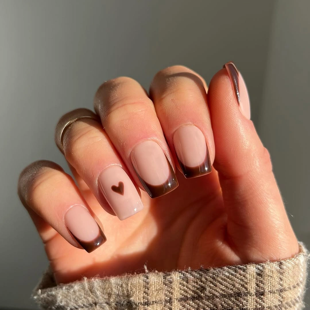 Short square pale pink nails with burgundy edges and heart accent