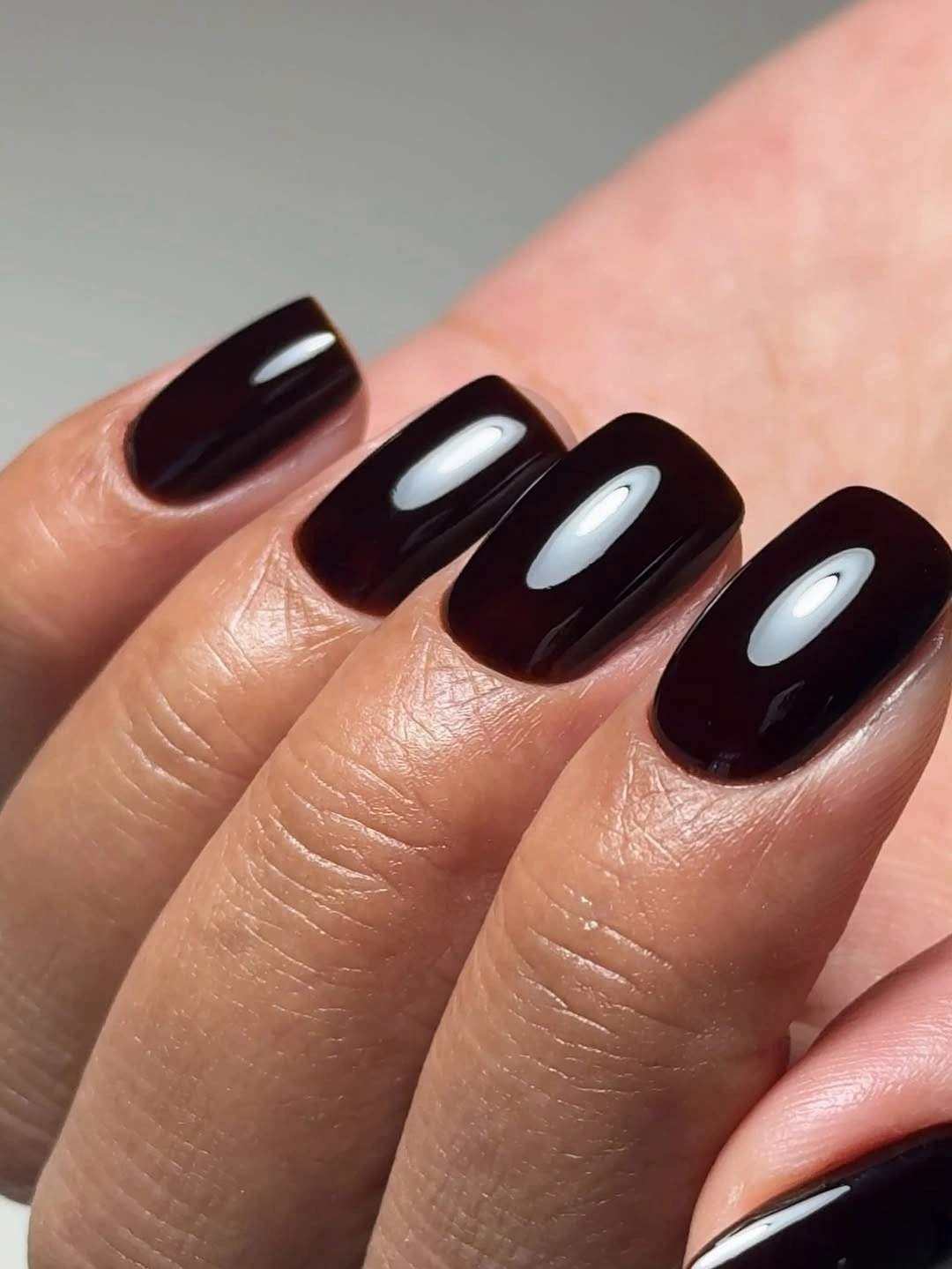 Medium square glossy black nails with white highlights