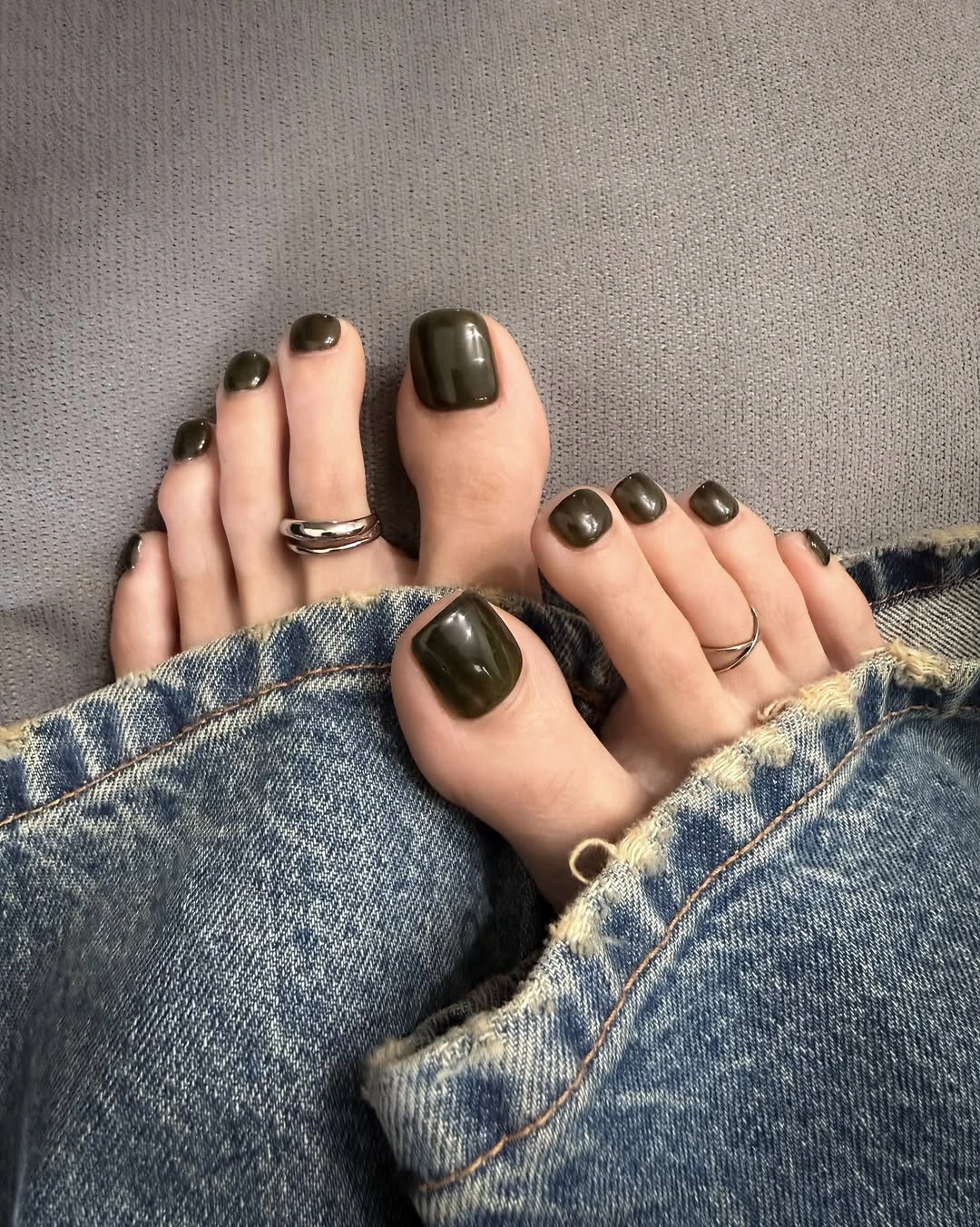 Glossy olive gray polish on short square toes