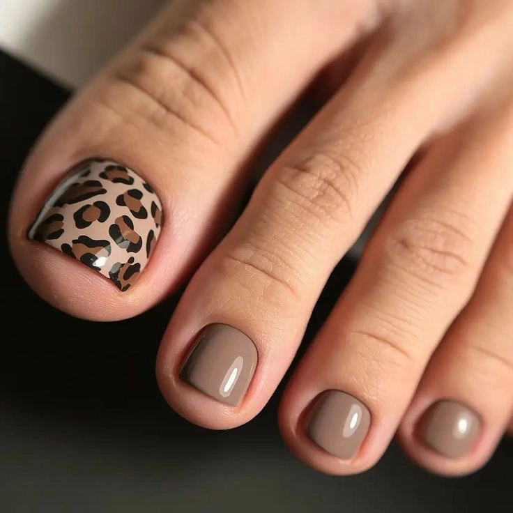 Taupe toes with one black and tan spotted accent