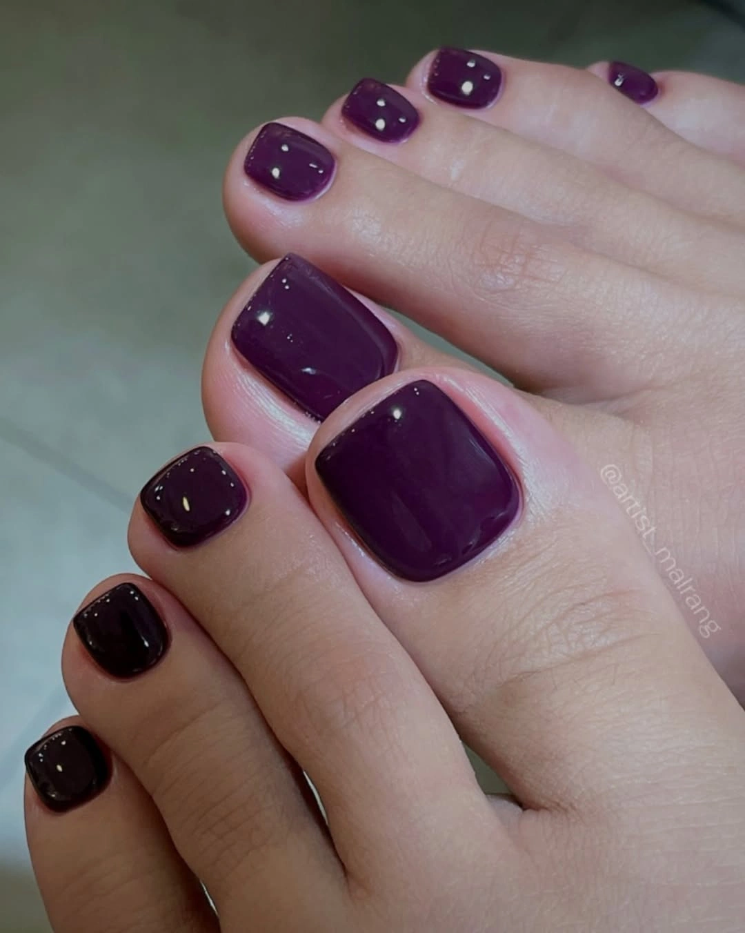 Glossy deep plum color across both feet