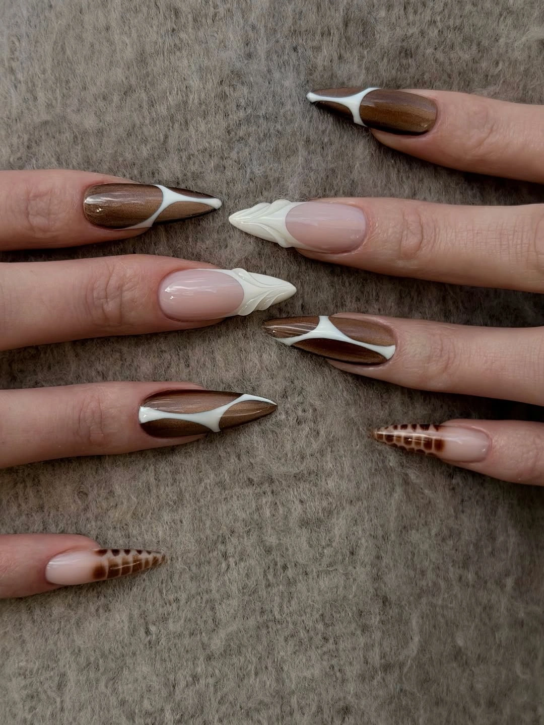Long pointed nails with sculptural brown and white details