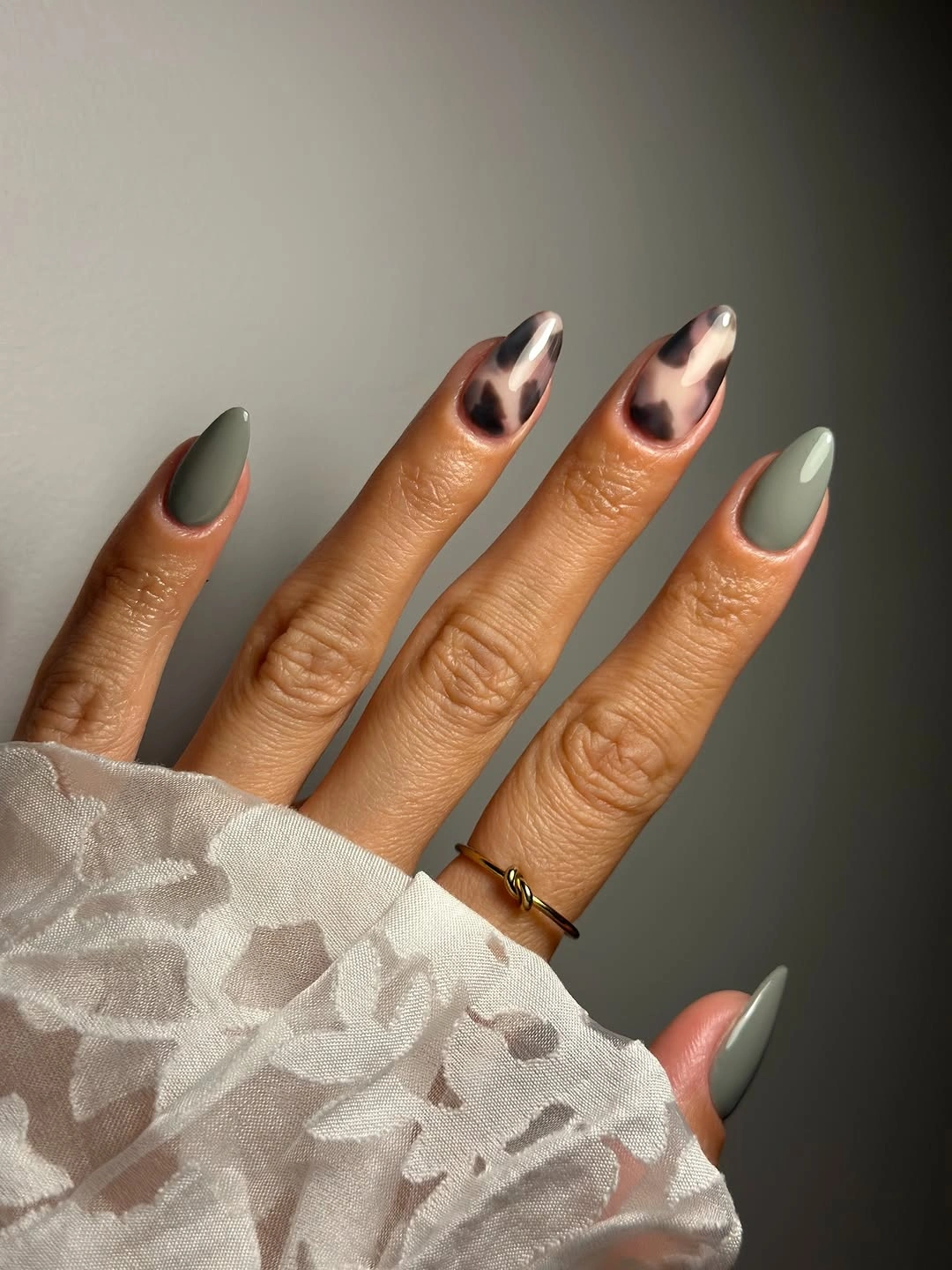 Sage almond nails with pale reflective accent details
