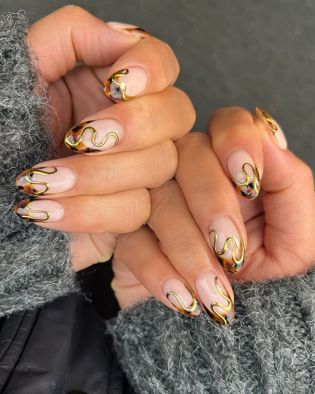 Sheer pink almond nails with delicate looping accents