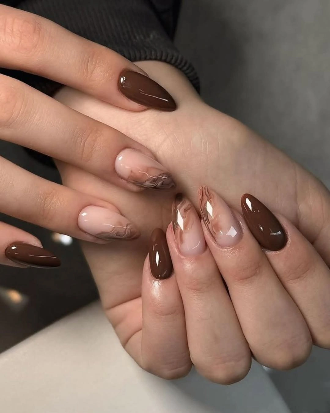 Chocolate almond nails with translucent brown swirl accents