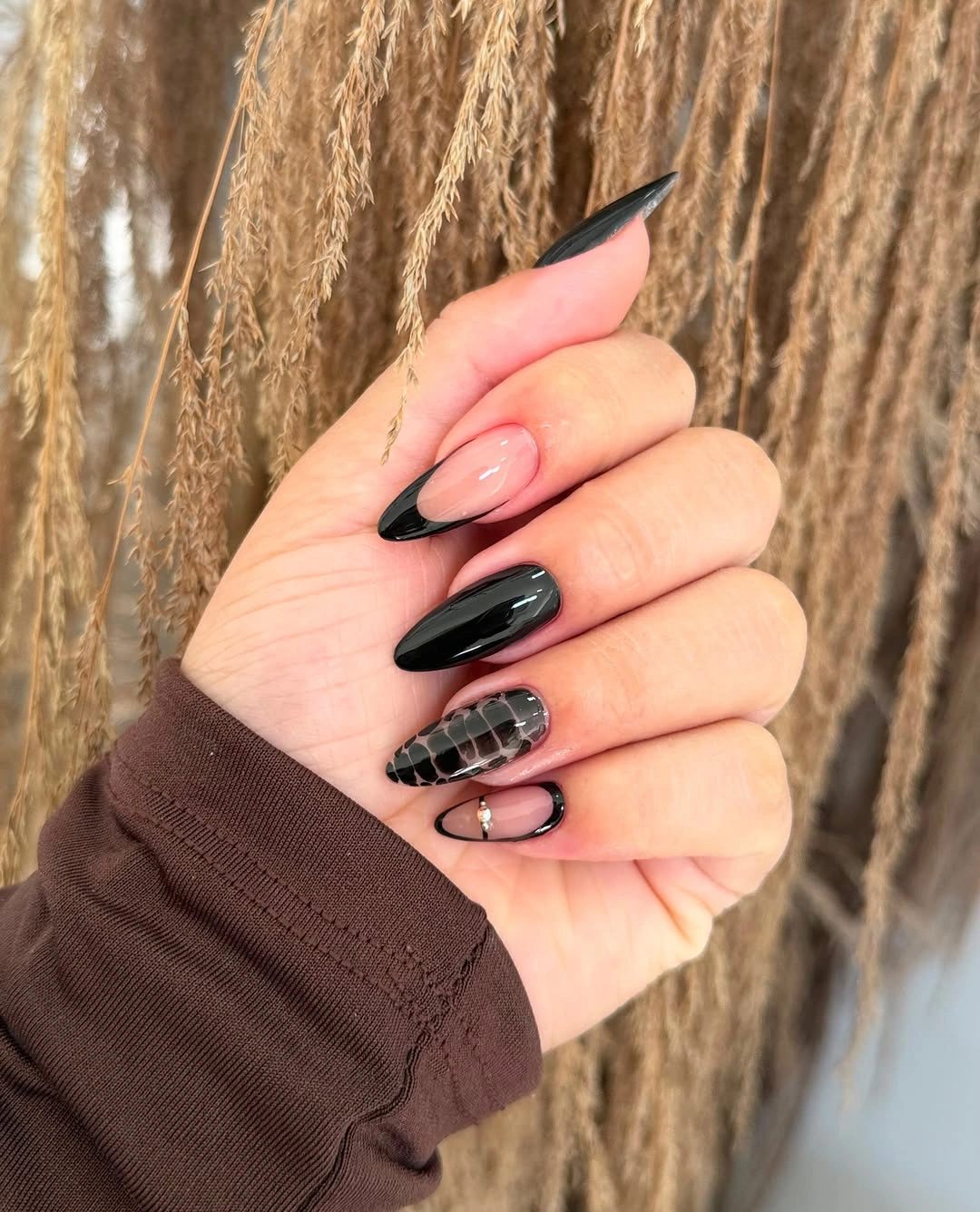 Black nude nails with one dark checked accent